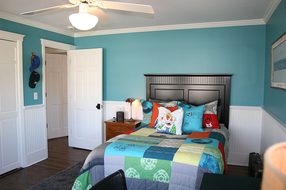 BLUE LAKE 2053-40, a rich teal, accents the surfboard, the patchwork duvet, and the energetic vibe of this teenager's room.